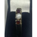 A 9 CARAT GOLD OPAL AND RUBY RING SIZE L WITH A PRESENTATION BOX