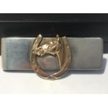 A TIFFANY AND CO SILVER NOTECLIP WITH A 9 CARAT GOLD HORSESHOE DECORATION