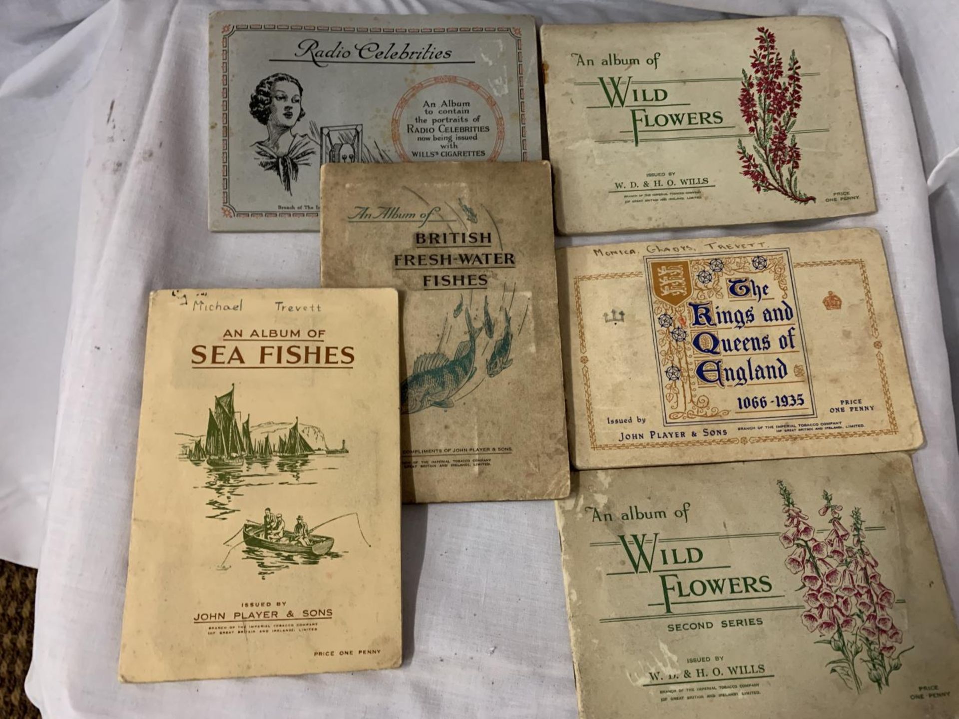 SIX ALBUMS CONTAINING CIGARETTE CARDS RADIO CELEBRITIES, WILD FLOWERS, KINGS AND QUEENS AND FISH