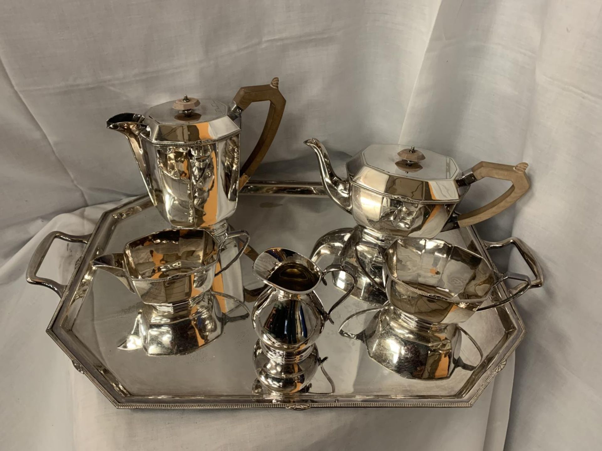 A LARGE SILVERPLATE TRAY WITH TWO SILVERPLATE TEA POTS, MILK AND CREAMER JUGS AND SUGAR BOWL