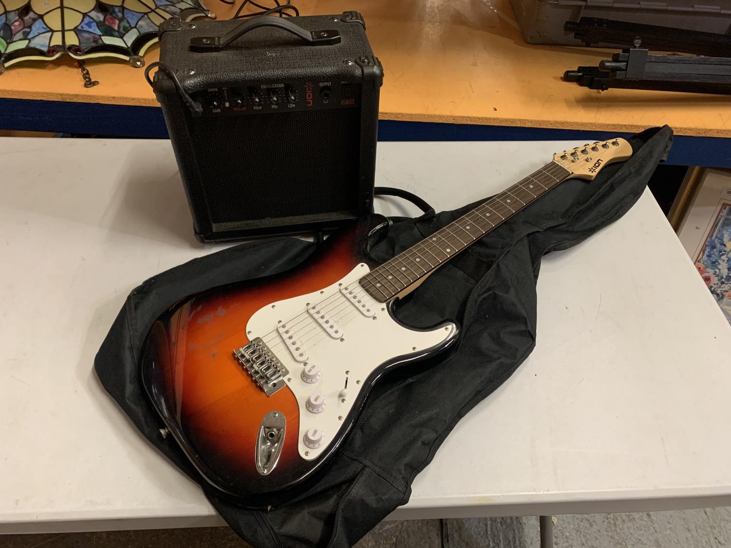 AN ION ELECTRIC GUITAR WITH CARRYING CASE AND AMPLIFIER