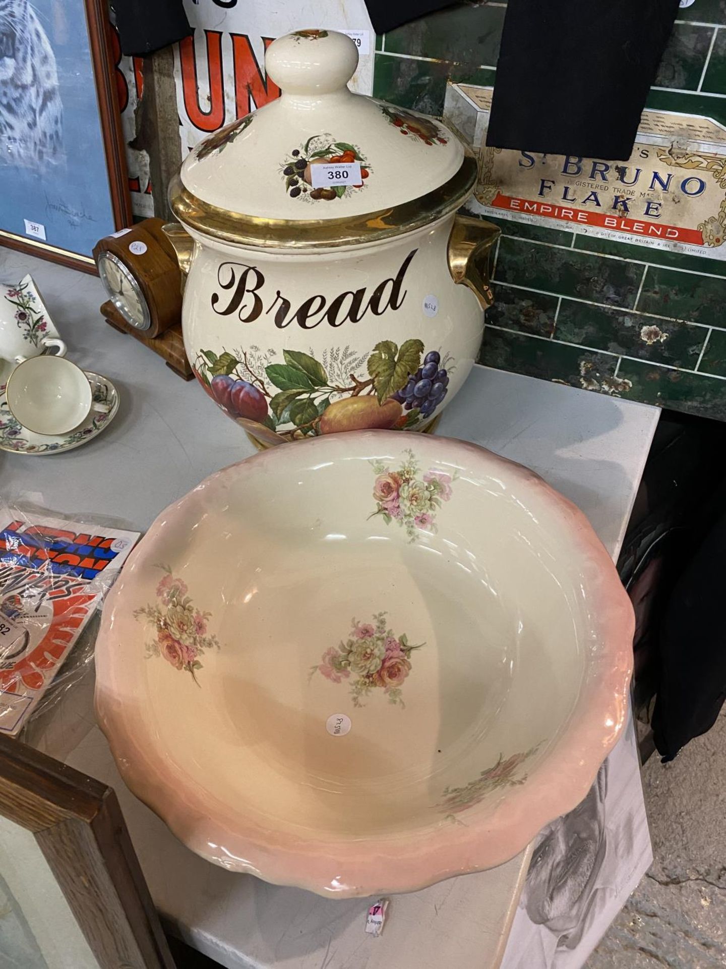 A LARGE LIDDED BREAD POT A/F HAIRLINE CRACK AND A BOWL