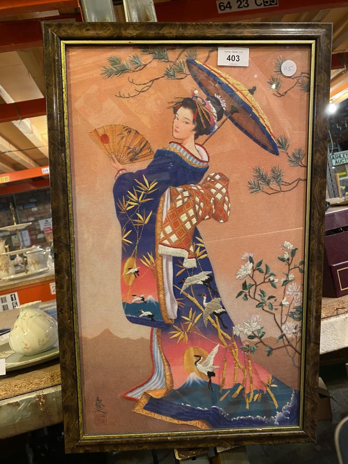 A FRAMED EMBRIODERED PICTURE OF A GEISHA GIRL SIGNED