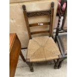 AN OAK JACOBEAN STYLE RUSH SEATED CHAIR