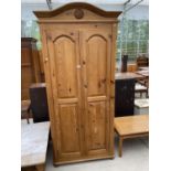 A PINE WARDROBE WITH TWO DOORS