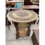 A HEAVILY CARVED ASIAN STYLE TABLE HAVING THREE TIERS, 23.5 DIAMETER