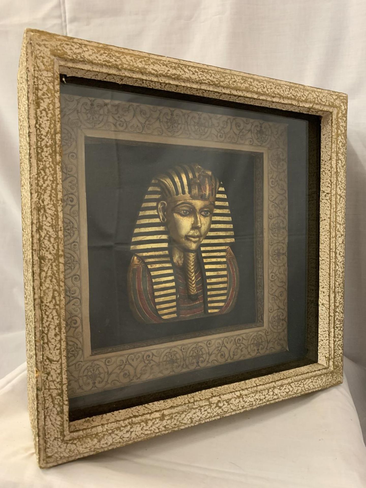 A GLASS DISPLAY BOX PRESENTING A BUST OF TUTANKHAMUN 41CM X 41CM