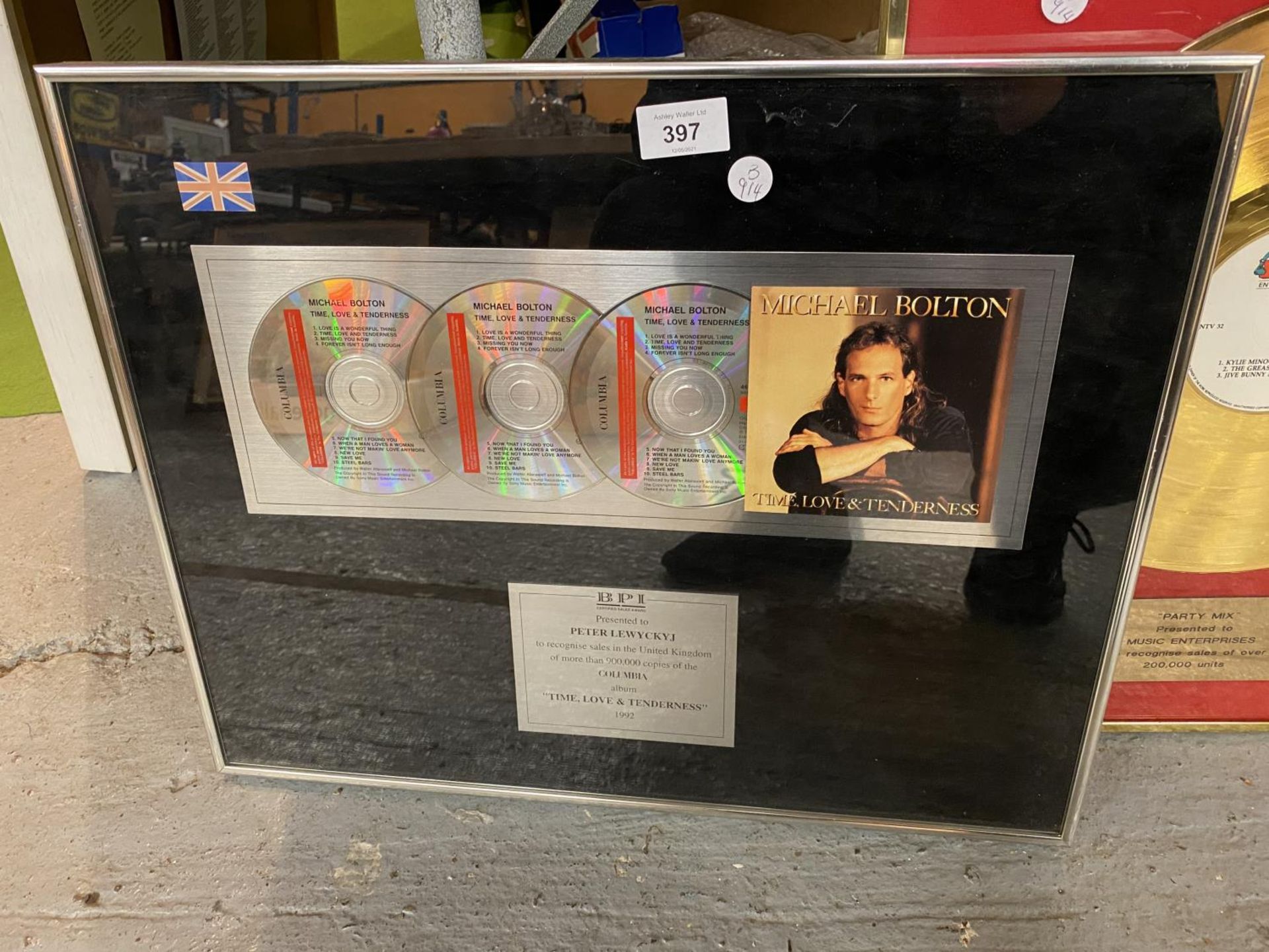 A FRAMED MICHAEL BOLTON PRSENTATION PICTURE RECOGNISING SALES FOR MORE THAN 900,000 COPIES