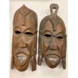 A PAIR OF HARDWOOD CARVED TRIBAL MASKS H: 43CM AND 40CM