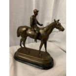 A SPELTER FIGURINE IN THE FORM OF A HORSE AND JOCKEY SIGNED C VALTON