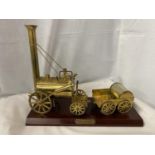 A BRASS STEPHENSONS ROCKET ON A MAHOGANY PLINTH