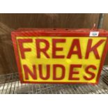 AN ILLUMINATED 'FREAK NUDES' SIGN