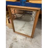 A WOODEN FRAMED MIRROR