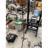 A TALL WROUGHT IRON CANDLESTICK