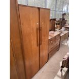 A RETRO TEAK TWO DOOR BEAUTILITY WARDROBE W: 36 INCHES