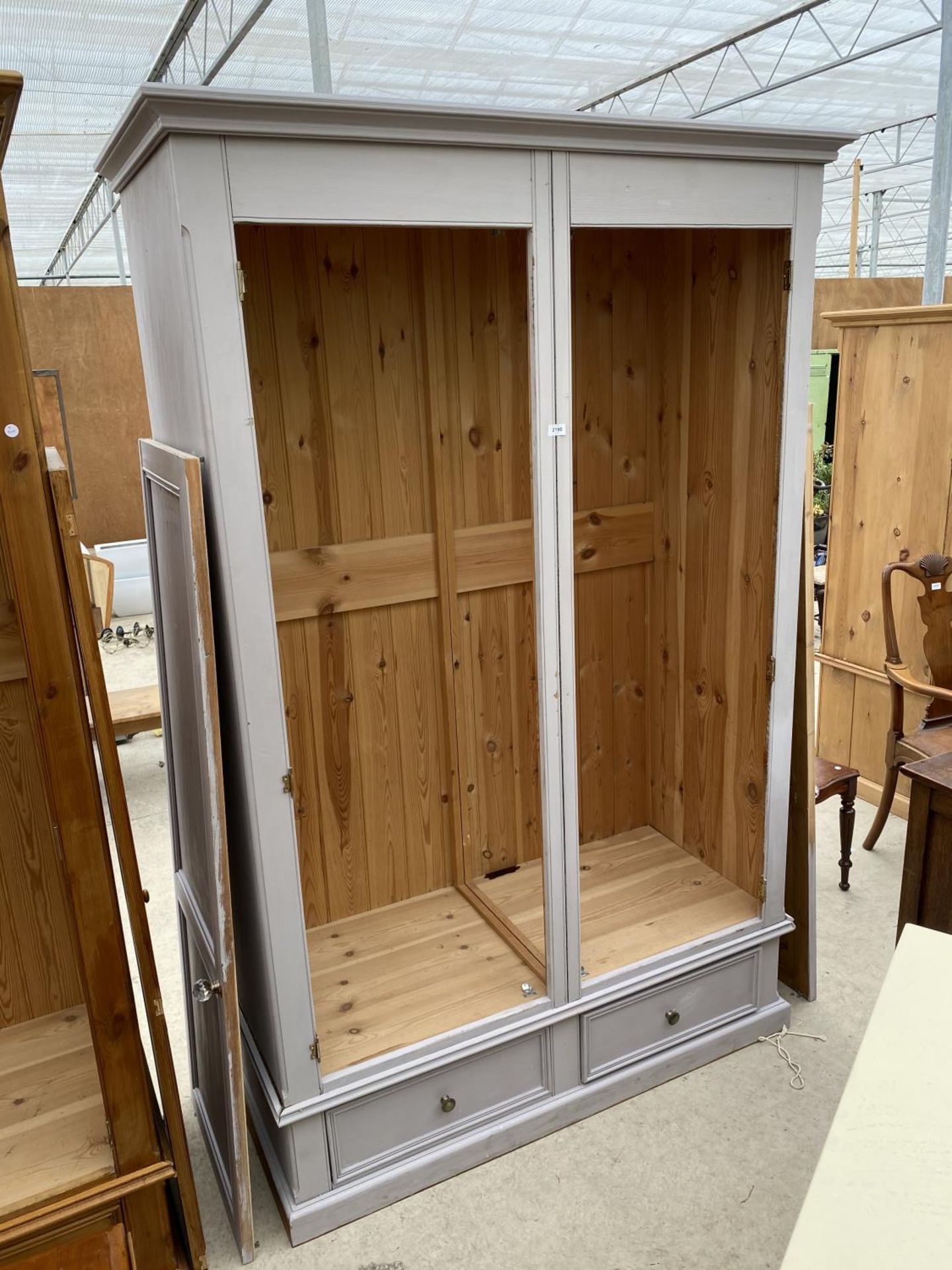 A MODERN PAINTED PINE TWO DOOR WARDROBE WITH TWO DRAWERS TO THE BASE 57" WIDE