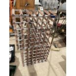 A PAIR OF WOODEN AND METAL FRAMED WINE RACKS