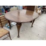 AN OVAL EDWARDIAN MAHOGANY WIND-OUT DINING TABLE WITH EXTRA LEAF, WINDER