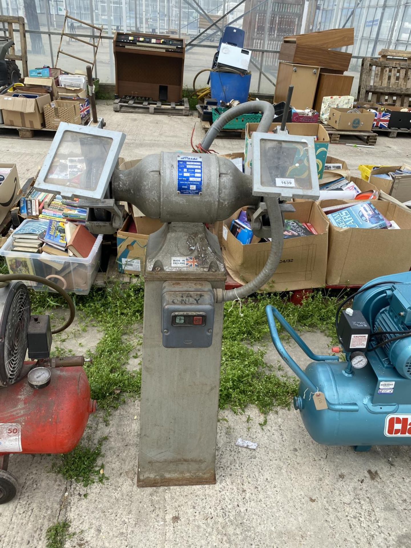 AN EG BENCH GRINDER ON A PEDASTAL BASE