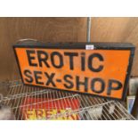 AN ILLUMINATED 'EROTIC SEX-SHOP' SIGN