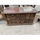 A CARVED HARDWOOD EIGHTEEN DRAWER SPICE CHEST, 26" WIDE