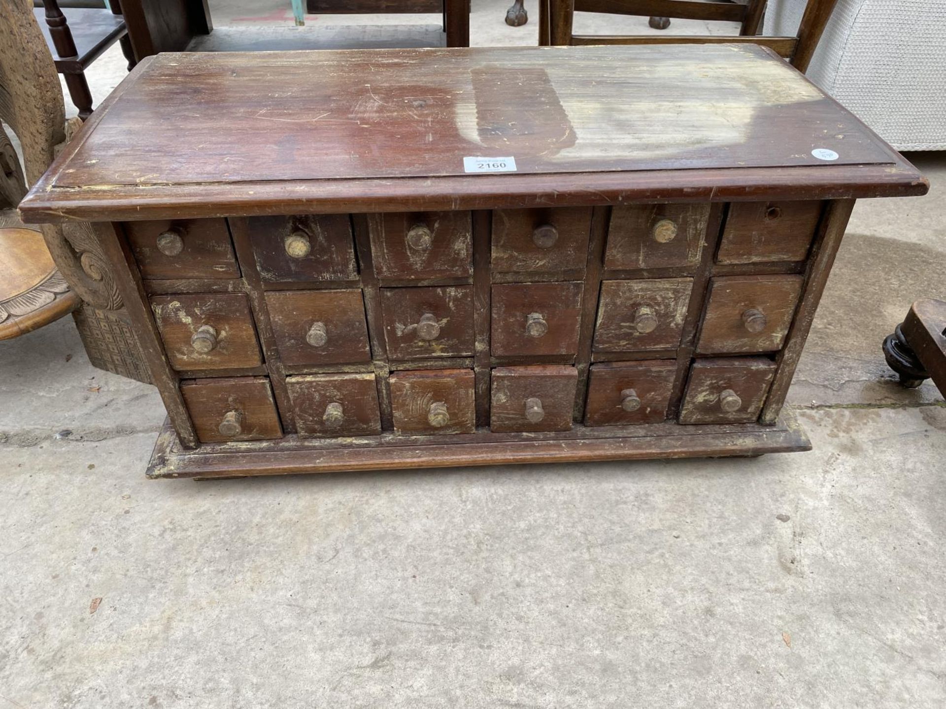 A CARVED HARDWOOD EIGHTEEN DRAWER SPICE CHEST, 26" WIDE