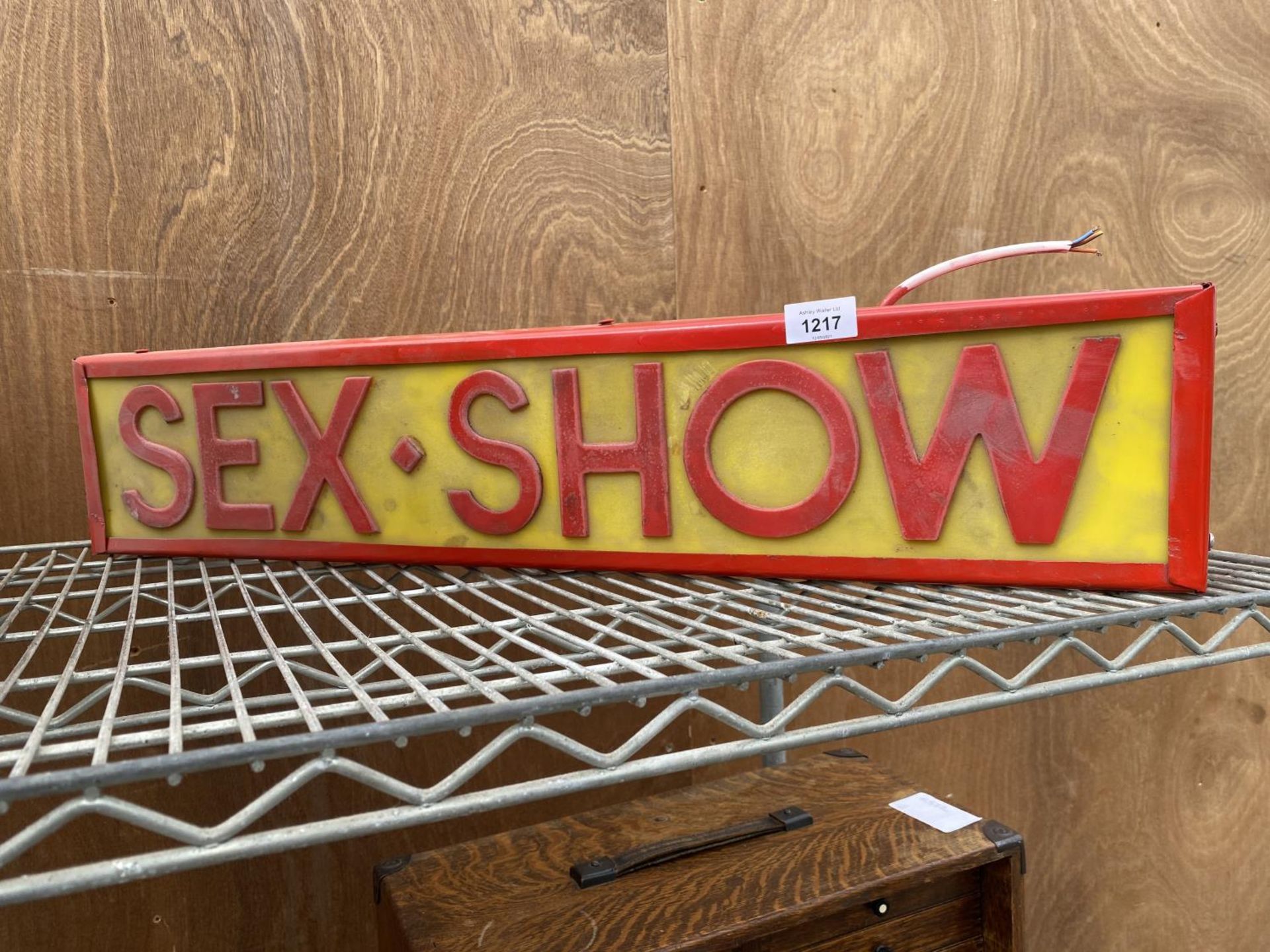 AN ILLUMINATED 'SEX-SHOW' SIGN