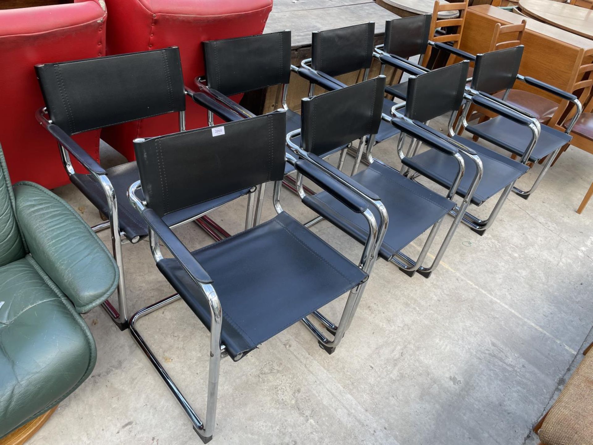 A SET OF EIGHT TUBULAR CHROME CANTILEVER CHAIRS