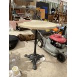 A FORMICA TOPPED TABLE WITH HEAVY CAST BASE