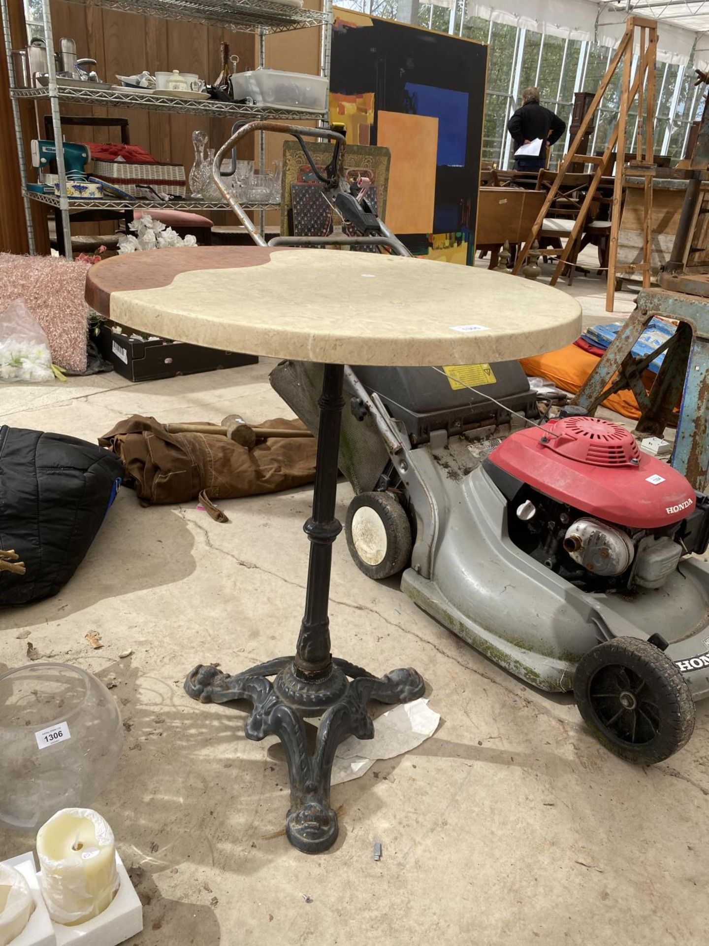 A FORMICA TOPPED TABLE WITH HEAVY CAST BASE