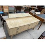 A MID 20TH CENTURY CREAM AND WALNUT EFFECT DRESSING TABLE ENCLOSING SIX DRAWERS