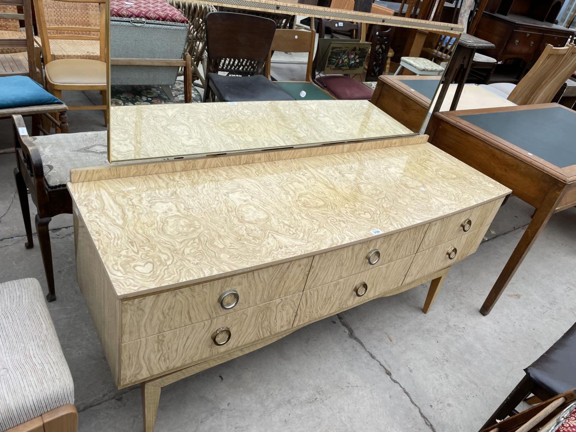 A MID 20TH CENTURY CREAM AND WALNUT EFFECT DRESSING TABLE ENCLOSING SIX DRAWERS