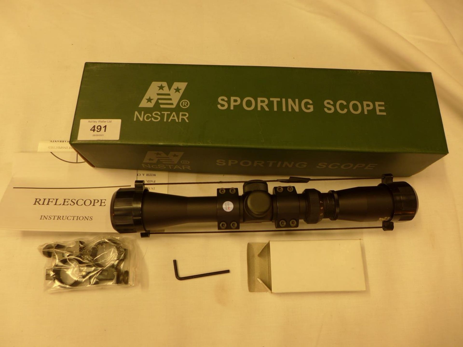 A BOXED NCSTAR 2-7X32 TELESCOPIC SIGHT AND MOUNTS