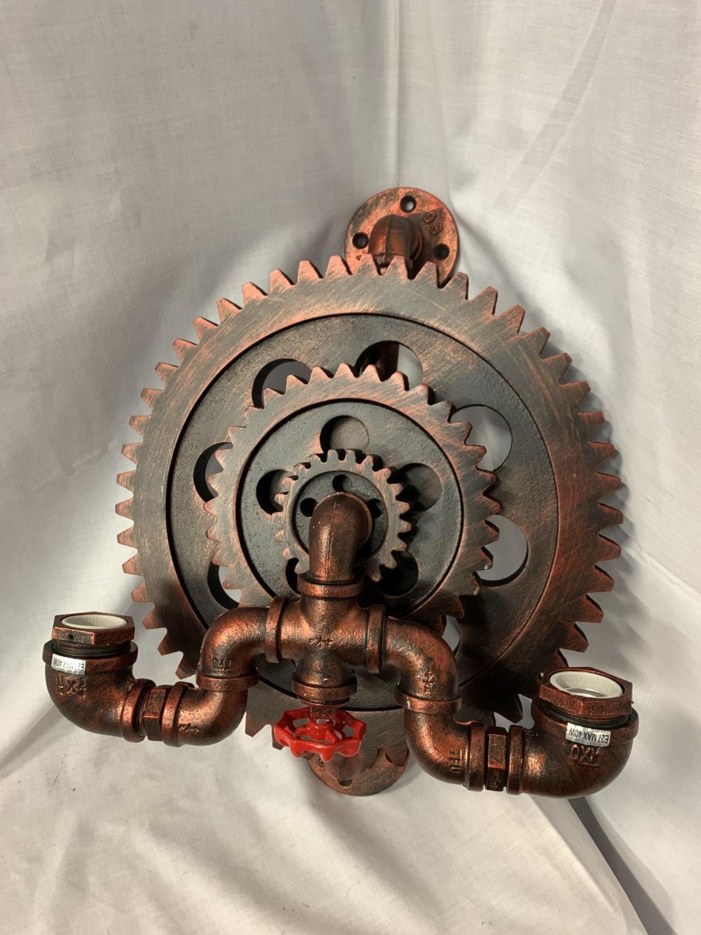 AN UNUSUAL TWIN WALL LIGHT IN AN INDUSTRIAL COG AND STEAM TAP DESIGN