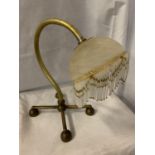 A BENSON BRASS TABLE LAMP WITH DECO GLASS SHADE AND FRINGE