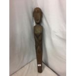 A WOODEN TRIBAL WALL MOUNTED FIGURE