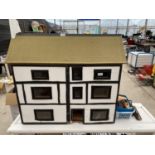 A LARGE BLACK AND WHITE WOODEN DOLLS HOUSE WITH AN ASSORTMENT OF DOLLS FURNITURE