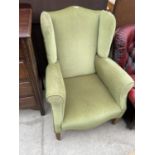 AN EDWARDIAN SPRUNG AND UPHOLSTERED WINGED EASY CHAIR