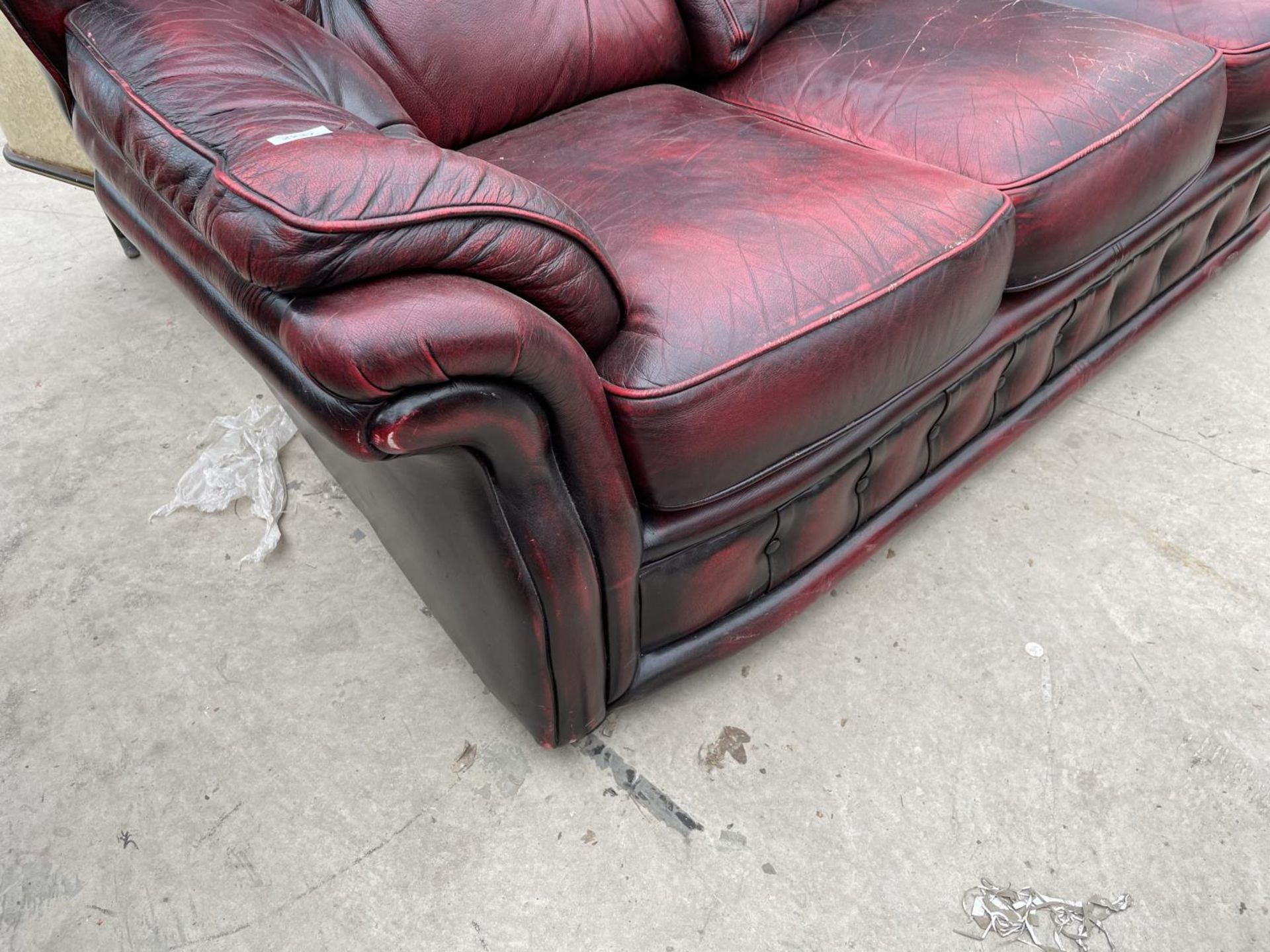 AN OXBLOOD BUTTON-BACK THREE SEATER SETTEE - Image 4 of 5