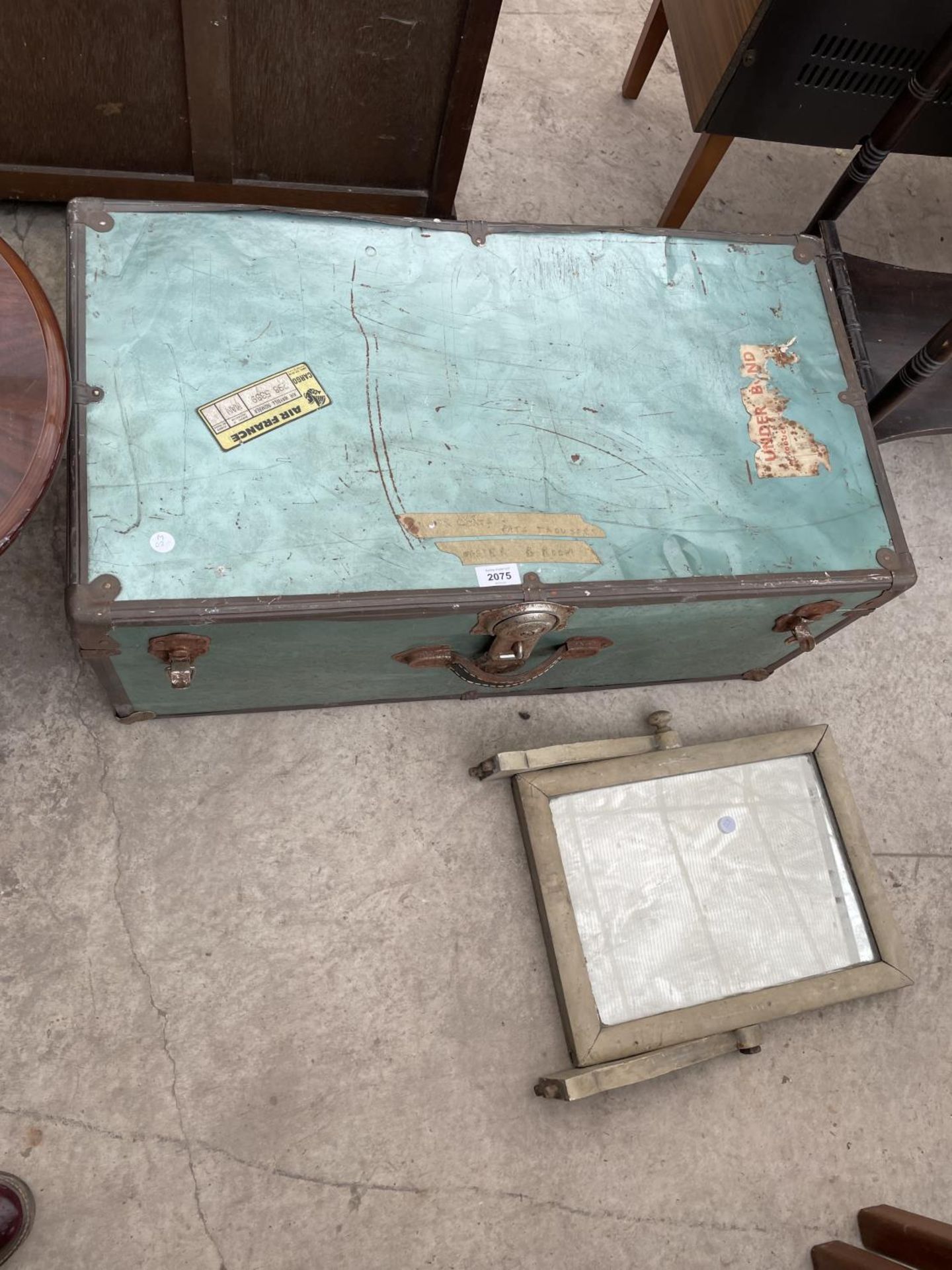A METAL FRAMED TRAVEL TRUNK AND PAINTED MIRROR