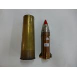 A TABLE LIGHTER IN THE FORM OF A ROCKET, THE TOP MADE FROM A SHELL FUSE, HEIGHT 30CM, AND A WORLD