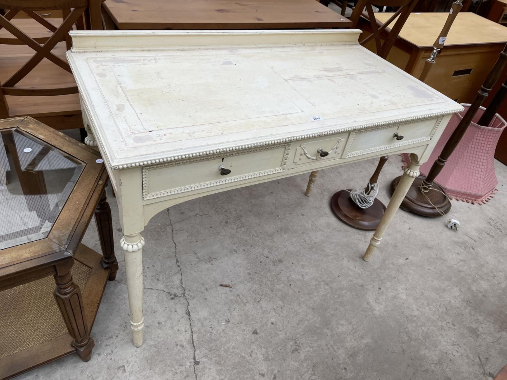 A WHITE PAINTED 19TH CENTURY STYLE TWO DRAWER SIDE TABLE ON TURNED TAPERING LEGS, 42" WIDE