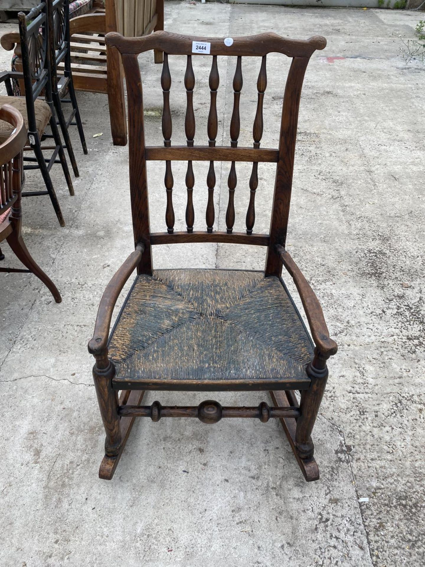 A LANCASHIRE SPINDLE BACK ROCKING CHAIR
