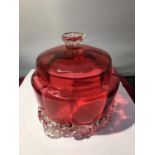 A CRANBERRY GLASS LIDDED POT WITH FLUTED BASE