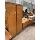 A MID 20TH CENTURY WALNUT DRESSING TABLE AND WARDROBE ON TAPERING LEGS