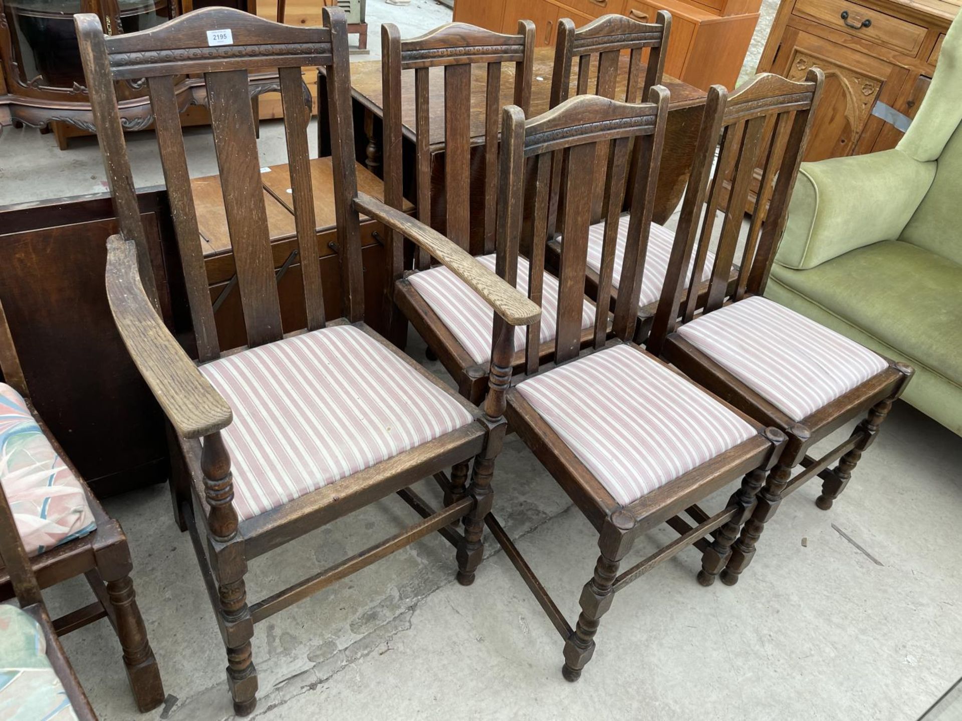 A SET OF SIX LATH BACK DINING CHAIRS, ONE BEING A CARVER