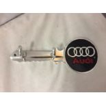 A METAL WALL MOUNTED 'AUDI' TWO HOOK KEY/COAT HOLDER IN THE SHAPE OF A KEY