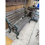 A VINTAGE WOODEN SLATTED GARDEN BENCH WITH CAST IRON LION HEAD BENCH ENDS