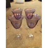 FOUR SLENDER STEMMED PURPLE TINTED WINE GLASSES
