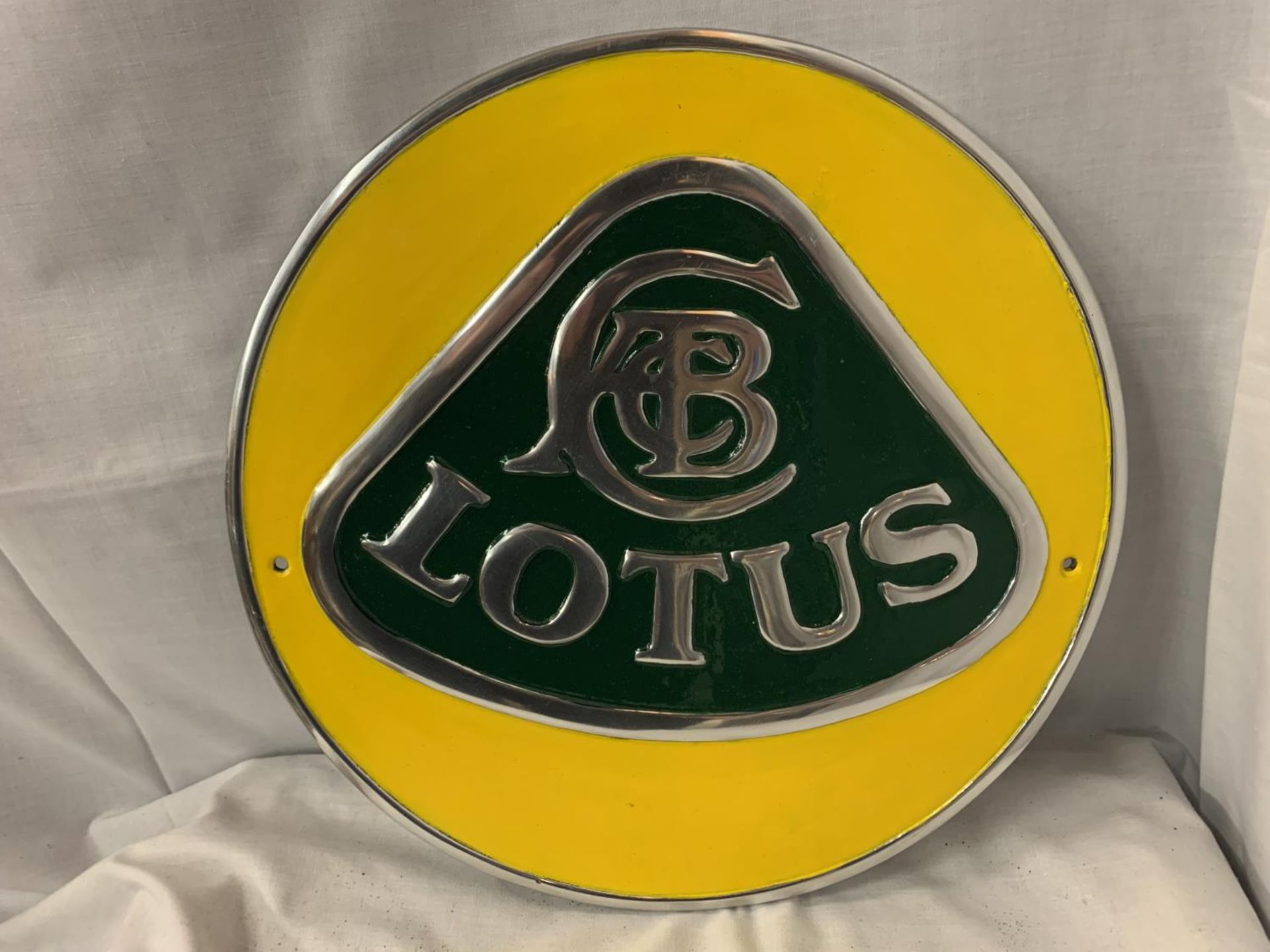 A LARGE CHROME LOTUS SIGN